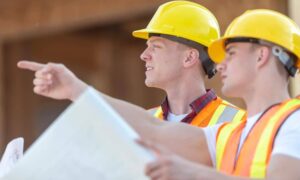 Land surveyors reviewing ALTA survey plans during a commercial site evaluation