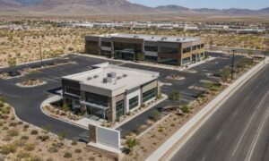 Aerial view of a commercial property in Nevada showing buildings, parking areas, driveways, and desert landscaping