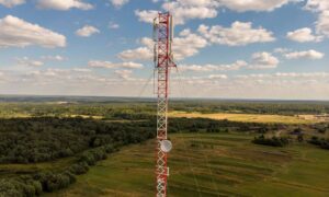 Cell tower standing on rural property, illustrating a lease area that may be defined by a property survey