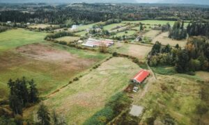 Aerial view of rural acreage and barns illustrating how a lot survey supports equestrian property planning