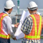 Engineers reviewing property plans at a Las Vegas construction site, highlighting the need for ALTA title surveys in growing urban areas

