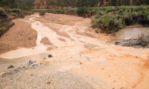 Desert runoff elevation surveys watershed management - ALTA SURVEY Nevada Muddy runoff flowing through a desert watershed area, demonstrating how elevation surveys help map water movement and manage flood risks in arid regions.