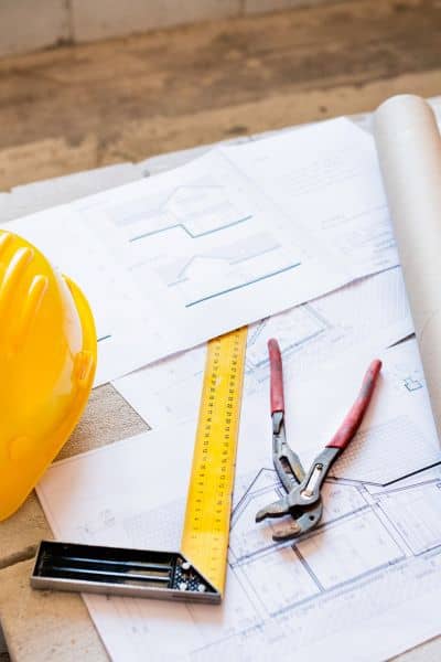 Layout plans verification - ALTA SURVEY Nevada Construction plans, tools, and safety helmet used for control verification during a construction staking survey