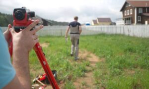 Surveyor preparing the yard layout before a construction survey for a remodel