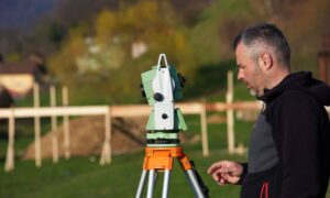 Land surveyor checking a residential property line survey before building a fence or wall
