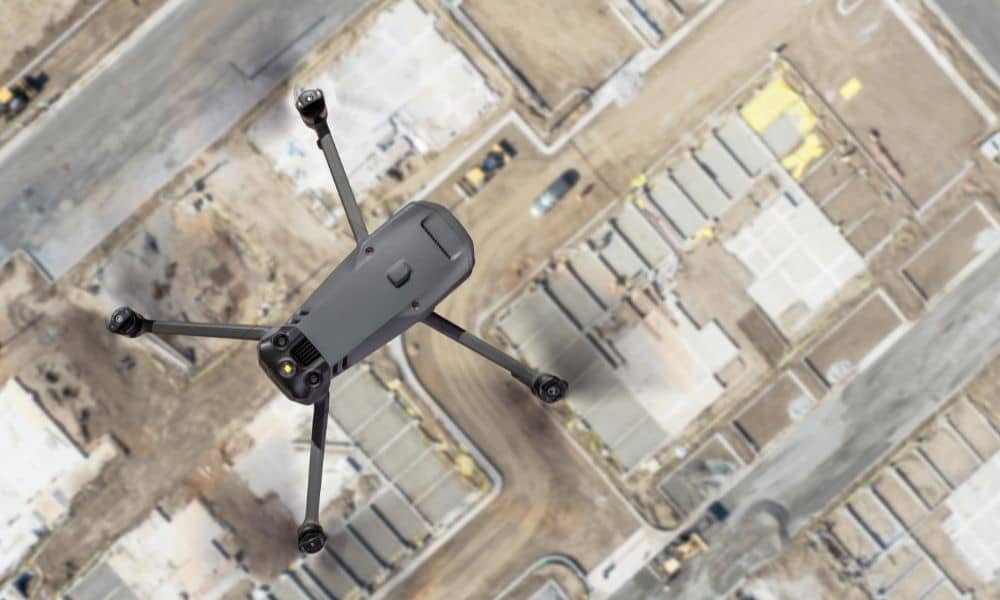 Drone surveying over an active industrial construction site in a growing desert development area