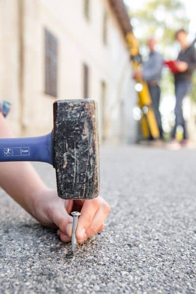 Licensed surveyor measuring property lines in the field during a lot survey